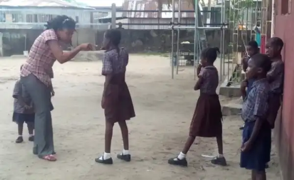 Photos: Teacher In Lagos Forces Her Pupil To Brush Teeth With Sand As Punishment